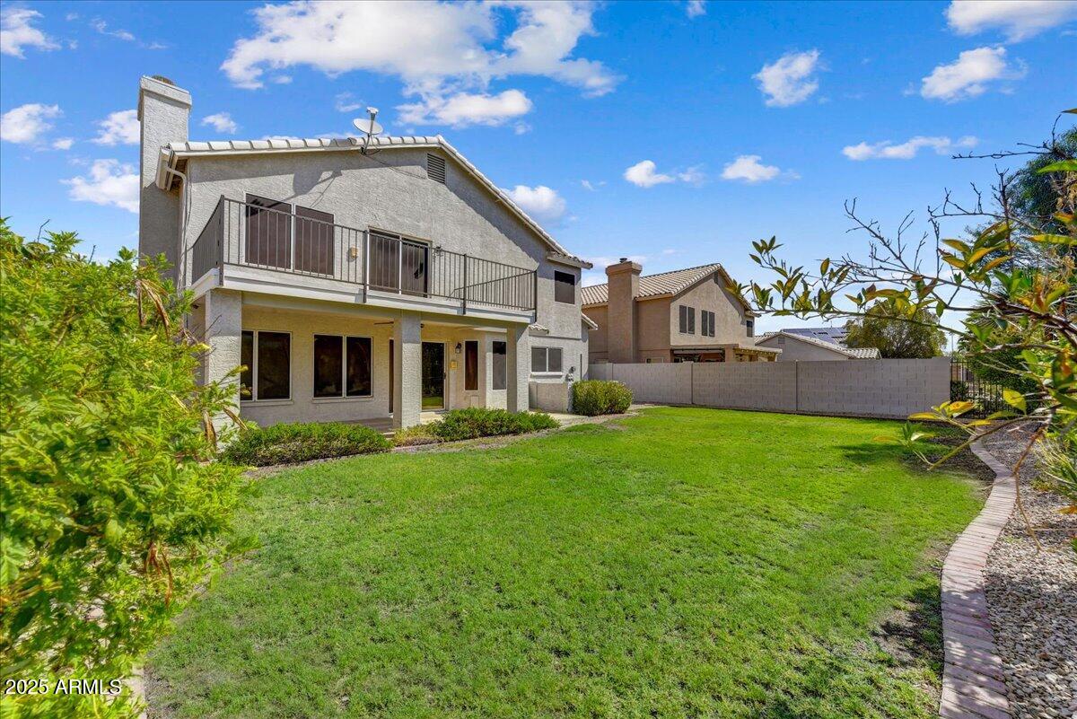 1691 West Commerce Avenue Gilbert, AZ 85233 - Photo 31 of 34 a front view of a house with a garden