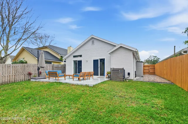 a front view of house with a garden and patio