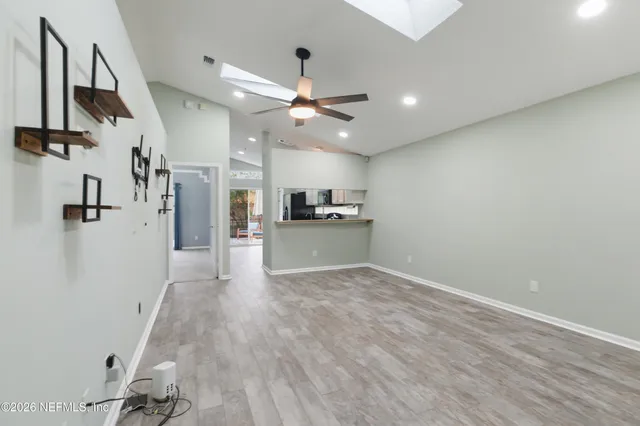 a view of a kitchen with a sink and a refrigerator