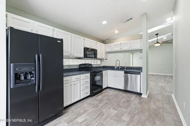 a kitchen with stainless steel appliances a refrigerator sink and microwave