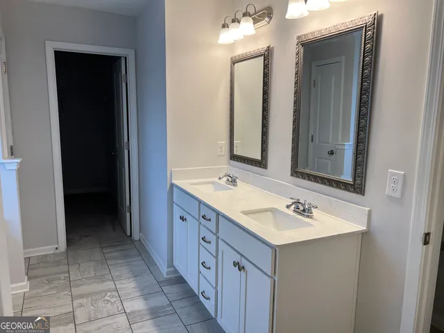 a bathroom with a sink vanity and mirror