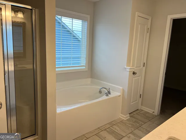 a white bath tub sitting next to a window