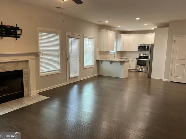 an open space with kitchen view and a fireplace