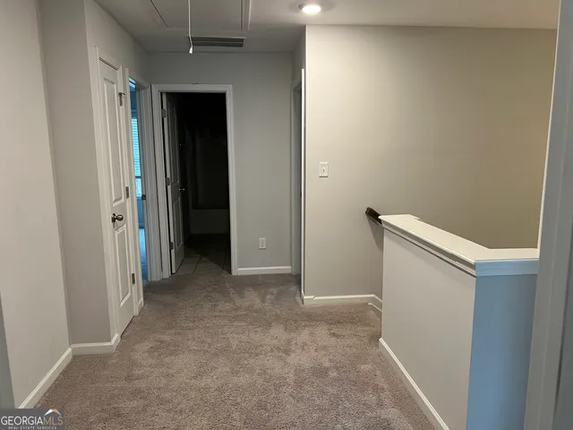 an entryway door with a hallway in the house