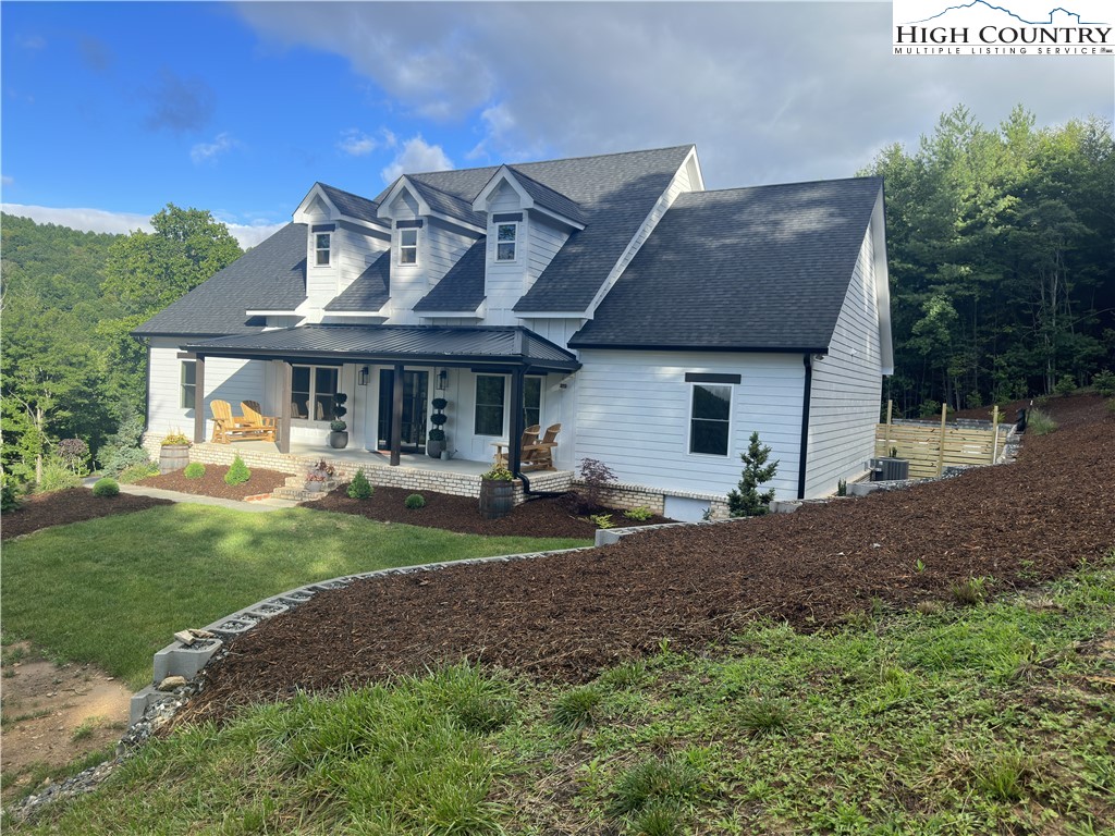 1701 Wildcat Road Deep Gap, NC 28618 - Photo 1 of 32 a front view of a house with garden