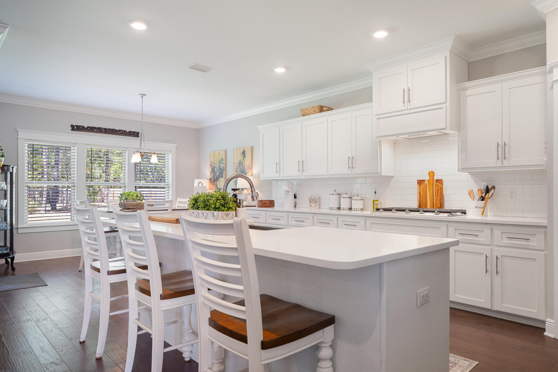 301 Mill Pond Cove Freeport, FL 32439 - Photo 26 of 55 a kitchen with a sink stools a counter space and cabinets