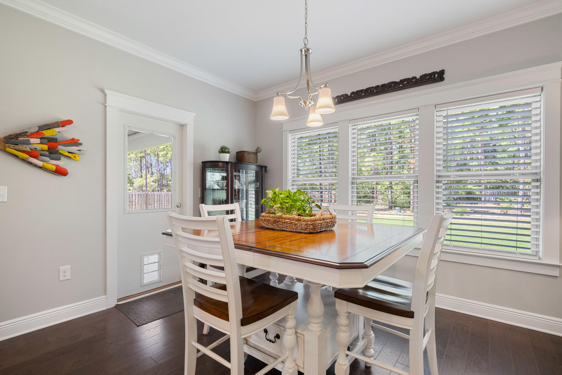 301 Mill Pond Cove Freeport, FL 32439 - Photo 27 of 55 a view of a dining room with furniture a chandelier and wooden floor
