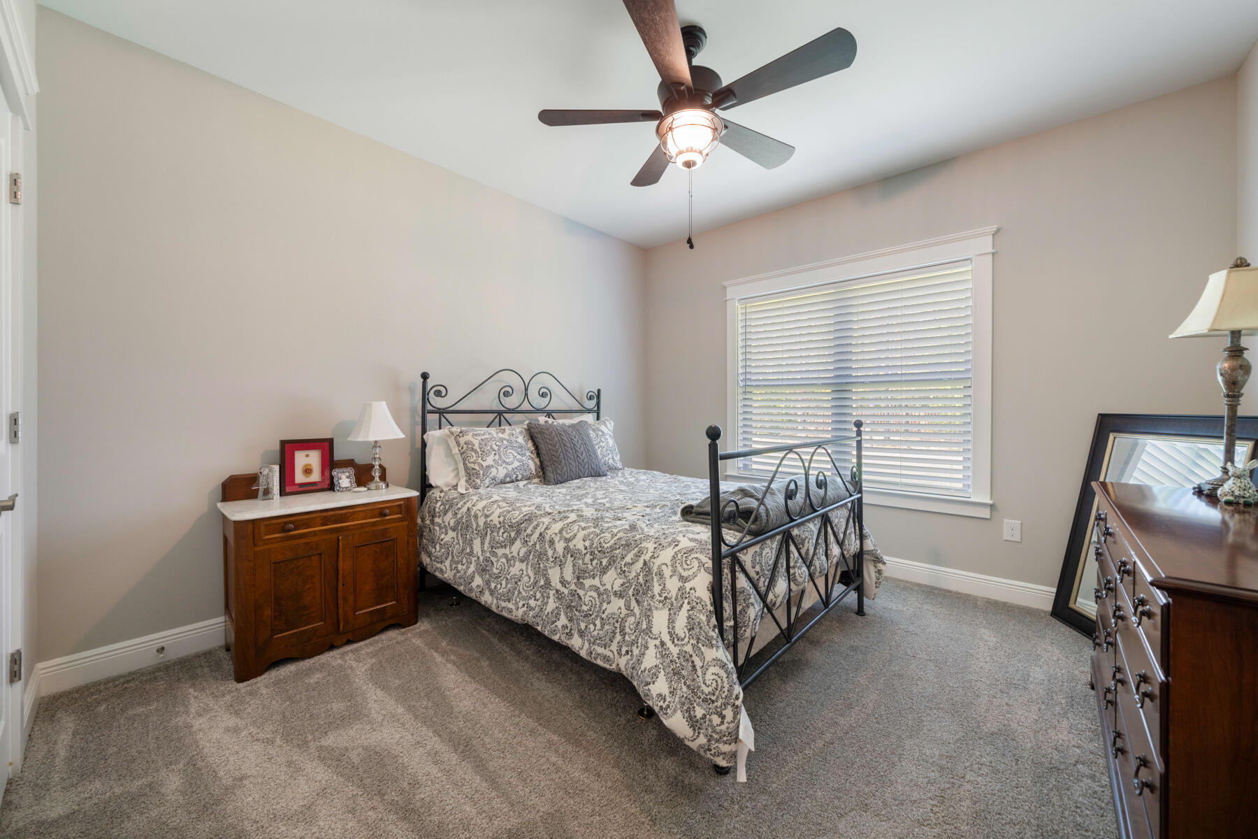 301 Mill Pond Cove Freeport, FL 32439 - Photo 32 of 55 a bedroom with a bed and a chandelier
