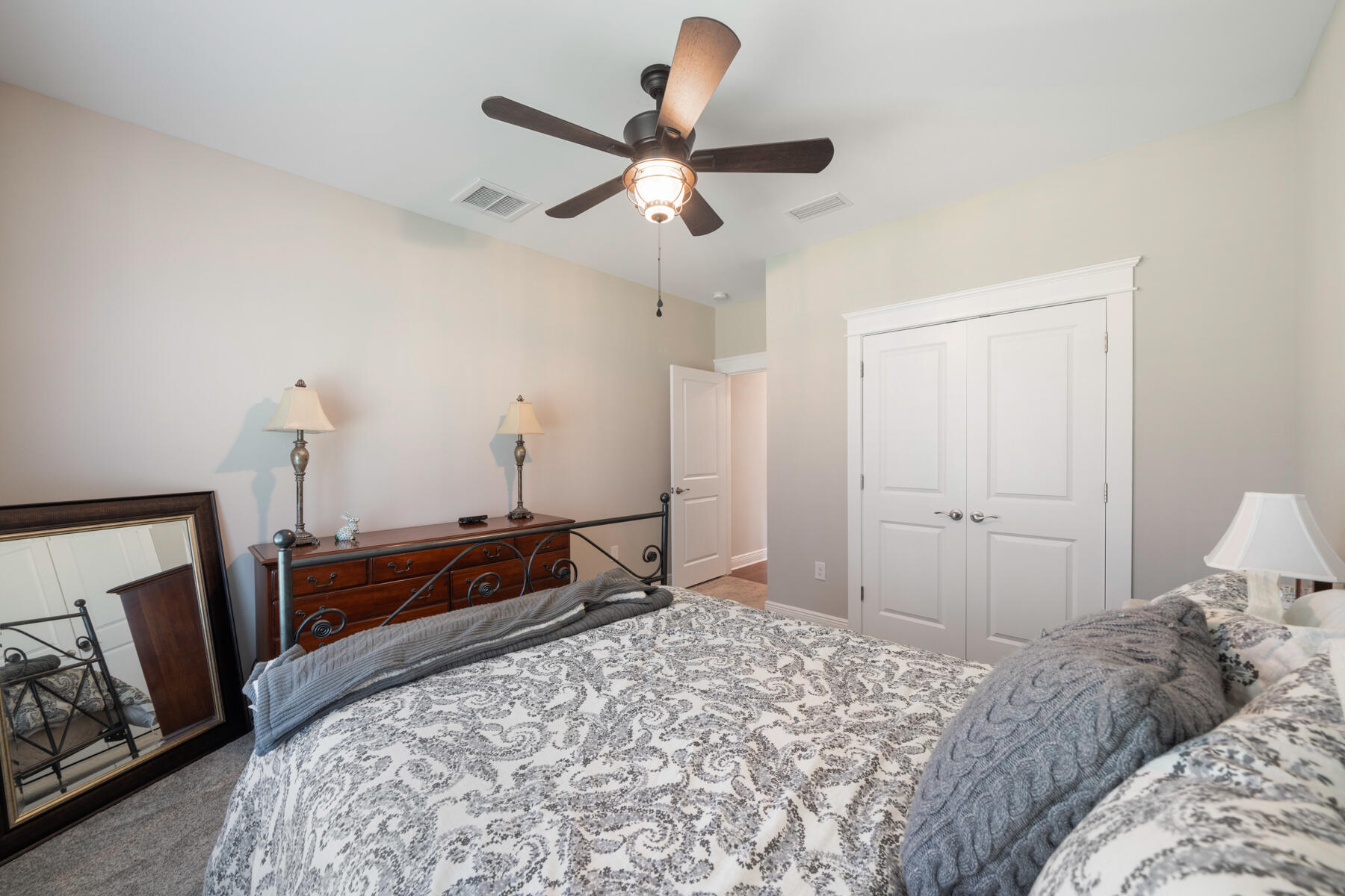 301 Mill Pond Cove Freeport, FL 32439 - Photo 33 of 55 a bedroom with a bed and a mirror on dresser