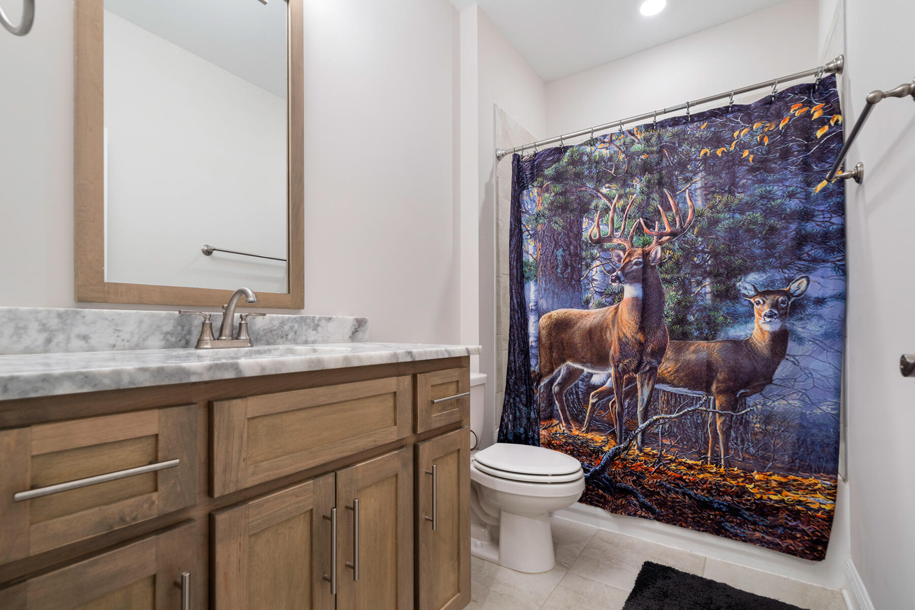 301 Mill Pond Cove Freeport, FL 32439 - Photo 46 of 55 a bathroom with a toilet a sink and a mirror