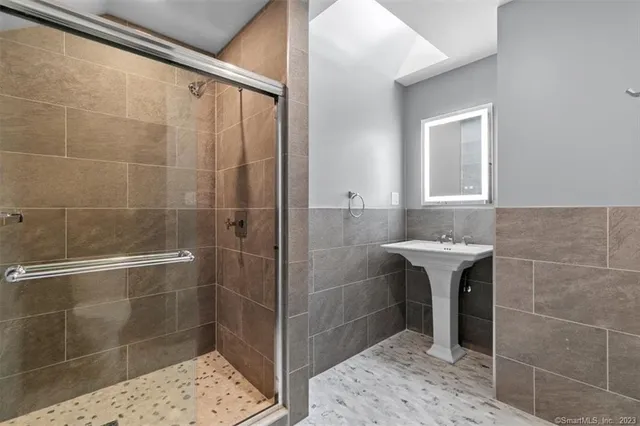 a bathroom with a shower and a sink