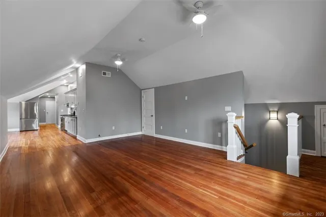 a view of a room with wooden floor