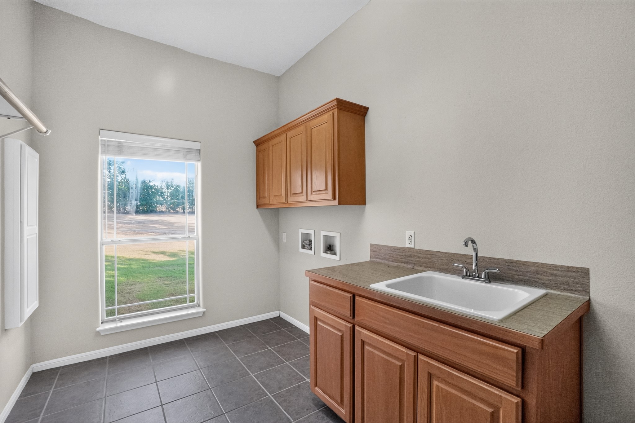986 High Grove Road Cedar Creek, TX 78612 - Photo 27 of 30 Functional workspace features built-in cabinetry, a deep basin sink, and tile flooring.