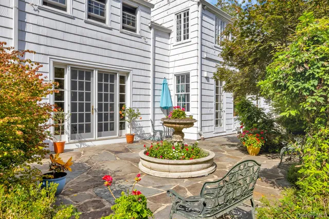 an aerial view of a house with a yard and large trees