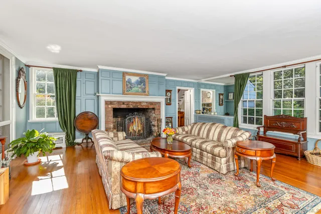 a living room with furniture a window and a fireplace