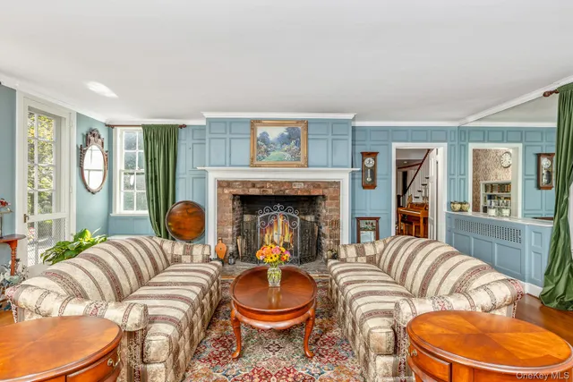 a living room with chairs and a table with wooden floor