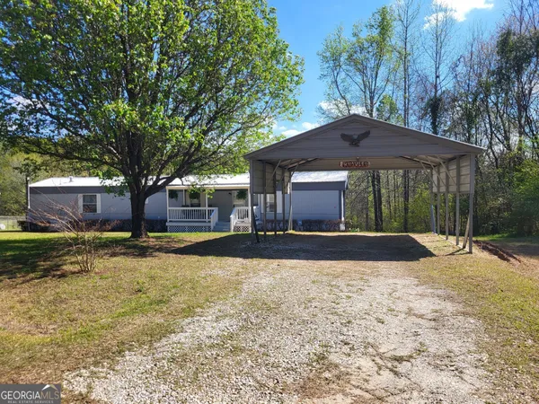 a view of a house with a yard and tree s
