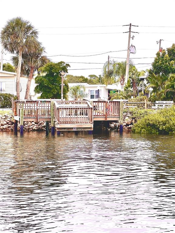 72 4th Avenue, Unit 72 Venice, FL 34285 - Photo 21 of 29 a view of a ocean with boats and trees in the background
