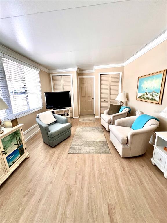 72 4th Avenue, Unit 72 Venice, FL 34285 - Photo 7 of 29 a living room with furniture and a flat screen tv