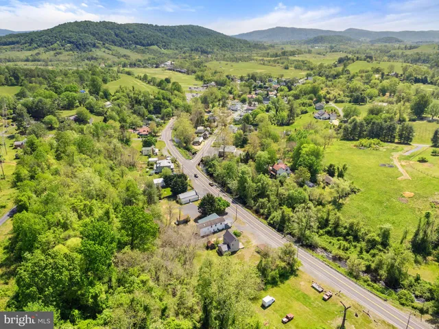 a view of a garden with mountains in the background