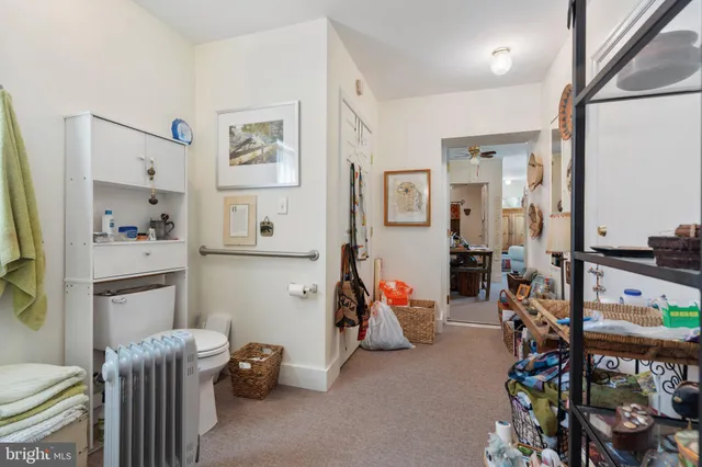 a open kitchen with a refrigerator a stove a sink dishwasher and a dining table with wooden floor