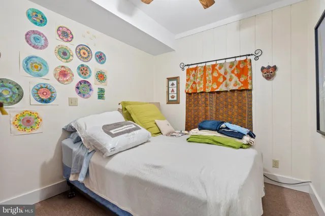 a view of a hallway with wooden floor and closet