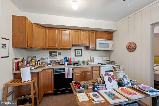 a living room filled with lots of furniture and a potted plant