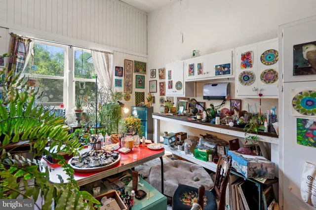 a view of a workspace with furniture and wooden floor