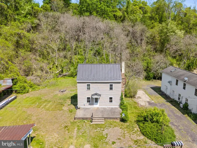 a view of house with outdoor space and seating area