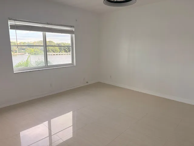 a bathroom with a granite countertop toilet sink and mirror