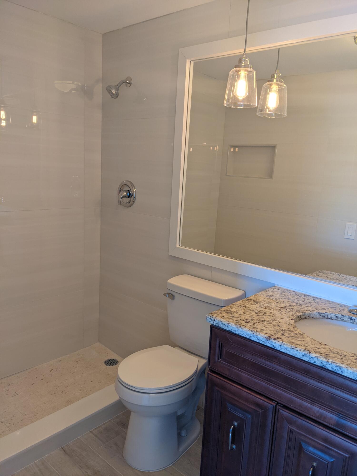 2772 Northeast 30th Avenue, Unit 6C Lighthouse Point, FL 33064 - Photo 16 of 16 a bathroom with a toilet a sink and shower