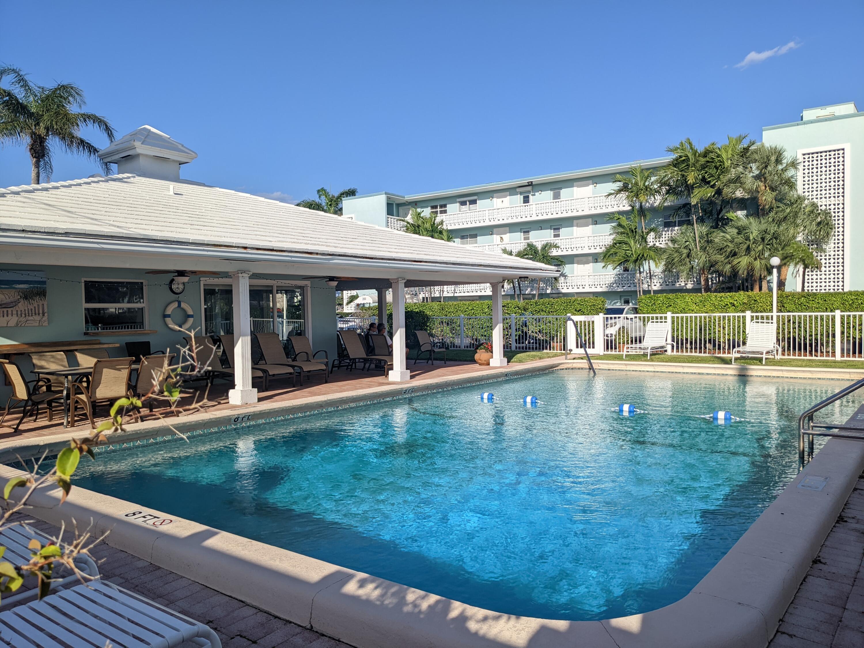 2772 Northeast 30th Avenue, Unit 6C Lighthouse Point, FL 33064 - Photo 5 of 16 a view of a swimming pool with a patio