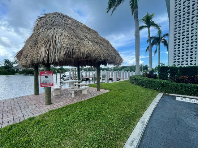 a couple of table and chairs under an umbrella in backyard