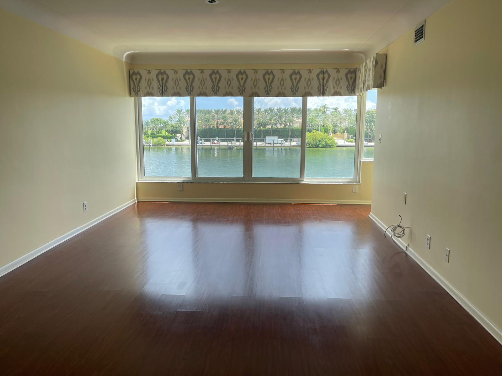 2772 Northeast 30th Avenue, Unit 6C Lighthouse Point, FL 33064 - Photo 7 of 16 a view of empty room with wooden floor and fan