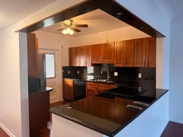a view of empty room with wooden floor and window
