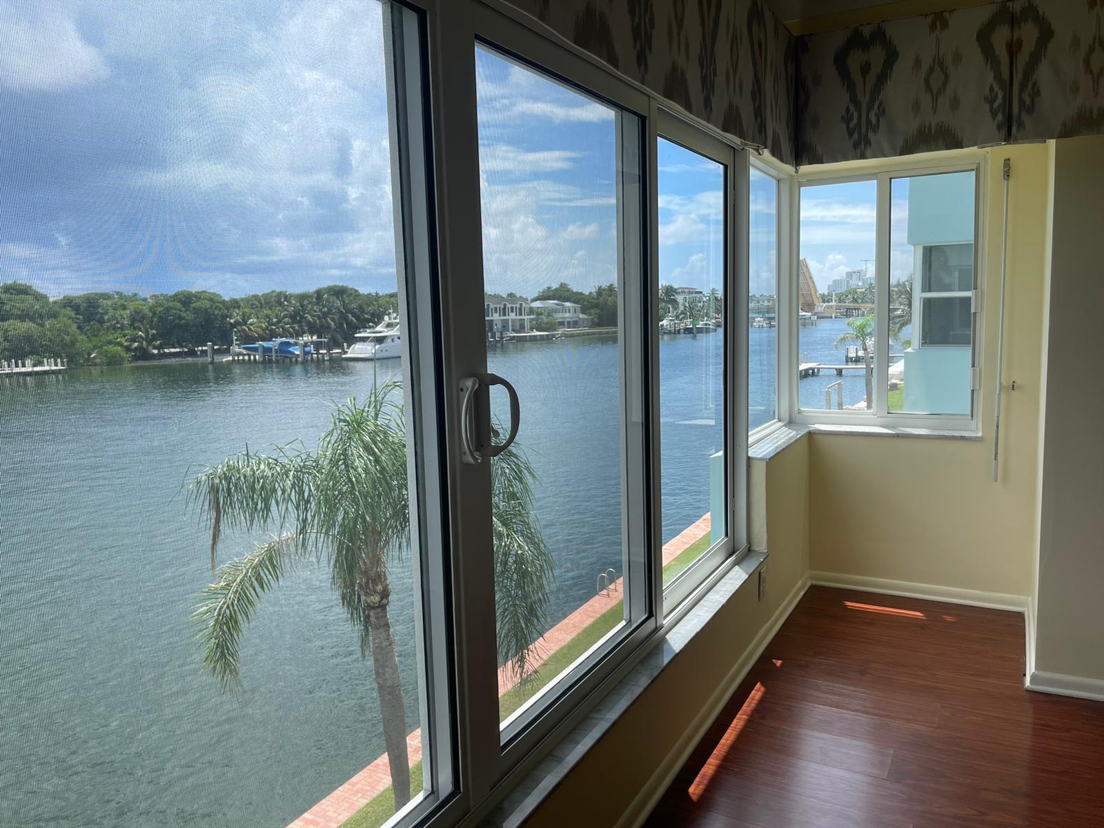 2772 Northeast 30th Avenue, Unit 6C Lighthouse Point, FL 33064 - Photo 8 of 16 a view of a balcony with lake view and a floor to ceiling window