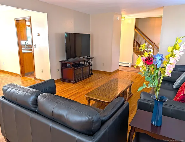 a living room with furniture and a flat screen tv