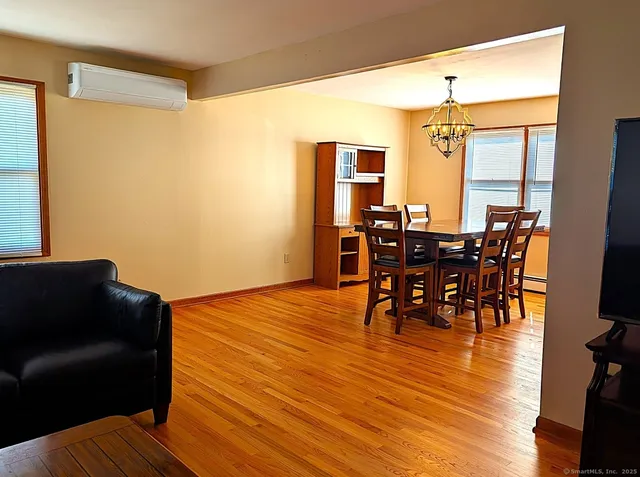a view of a dining room with furniture and wooden floor