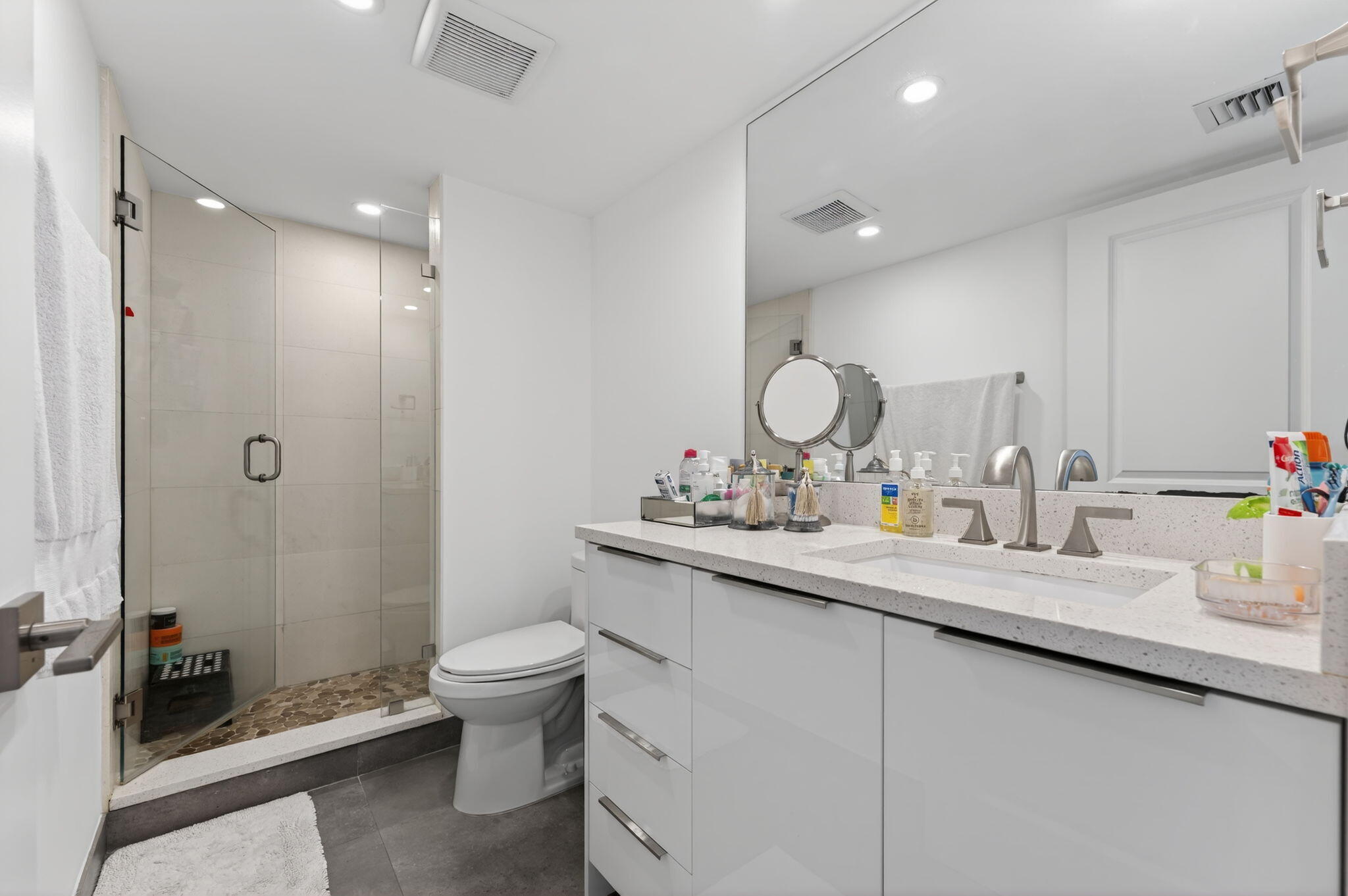 4301 North Ocean Boulevard, Unit 1206 Boca Raton, FL 33431 - Photo 37 of 71 a bathroom with a sink a toilet and a mirror
