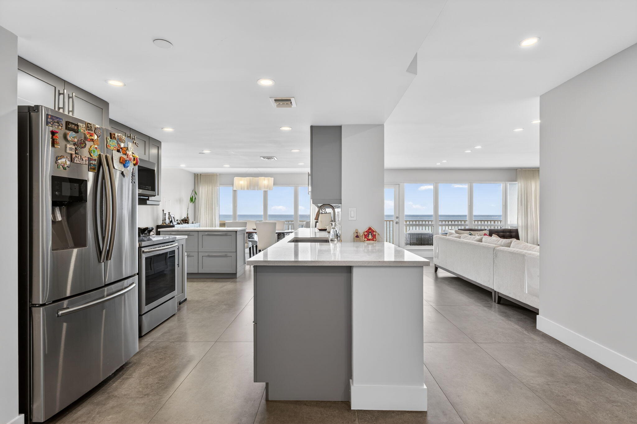 4301 North Ocean Boulevard, Unit 1206 Boca Raton, FL 33431 - Photo 6 of 71 a kitchen with stainless steel appliances a refrigerator a stove a sink and a center island