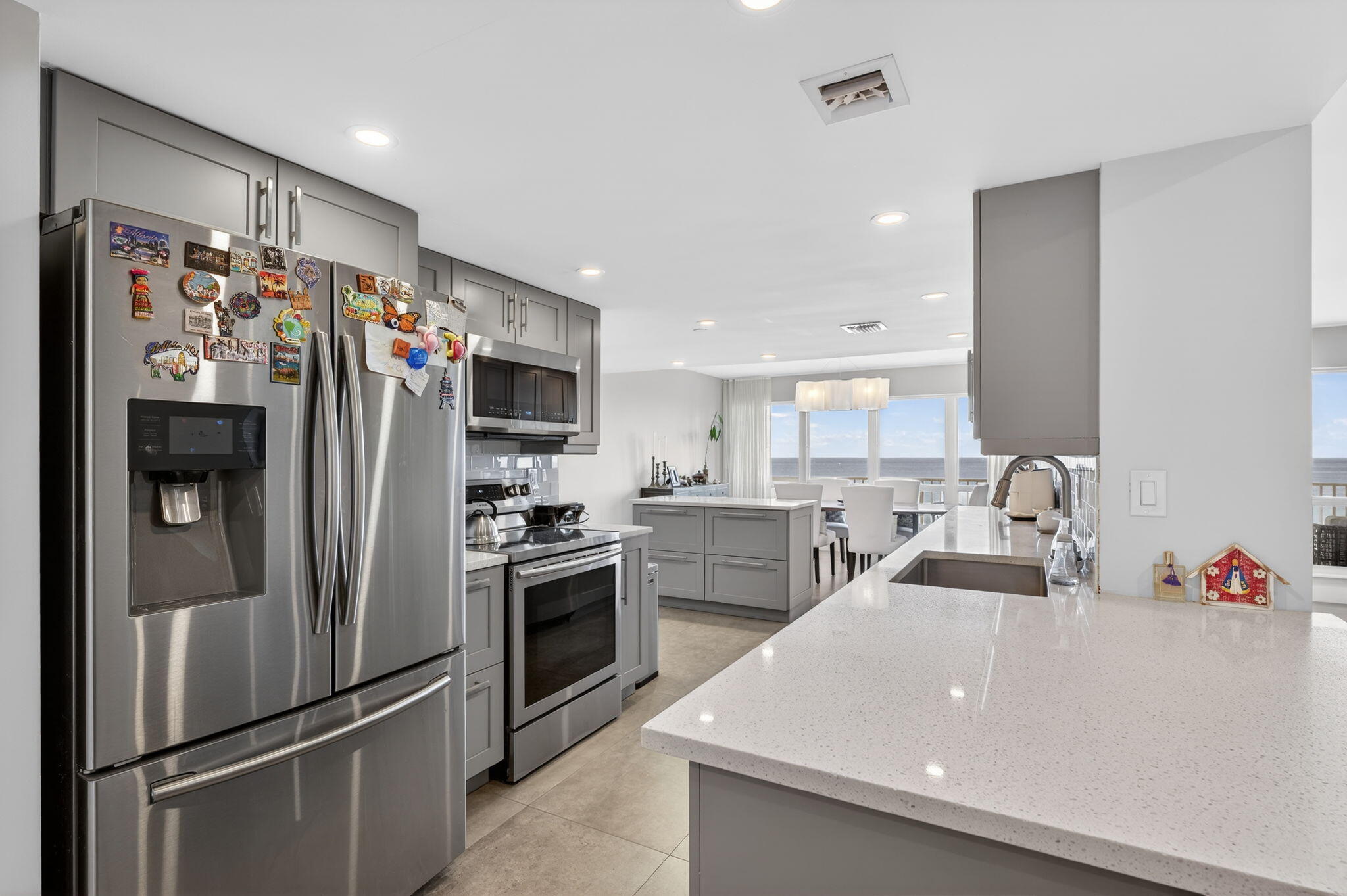 4301 North Ocean Boulevard, Unit 1206 Boca Raton, FL 33431 - Photo 8 of 71 a kitchen with stainless steel appliances granite countertop a refrigerator and a sink