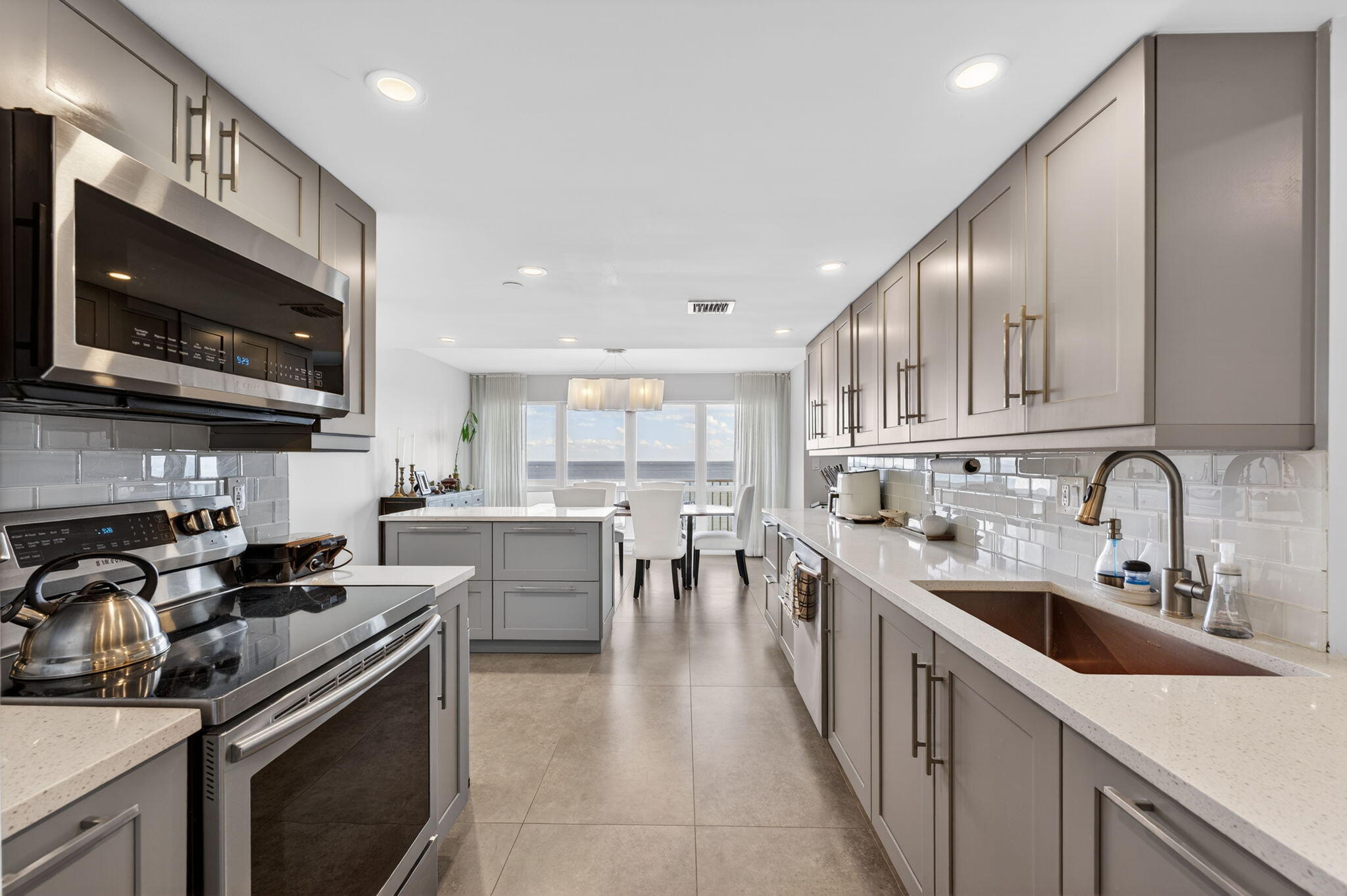 4301 North Ocean Boulevard, Unit 1206 Boca Raton, FL 33431 - Photo 10 of 71 a kitchen with lots of counter top space a sink and appliances