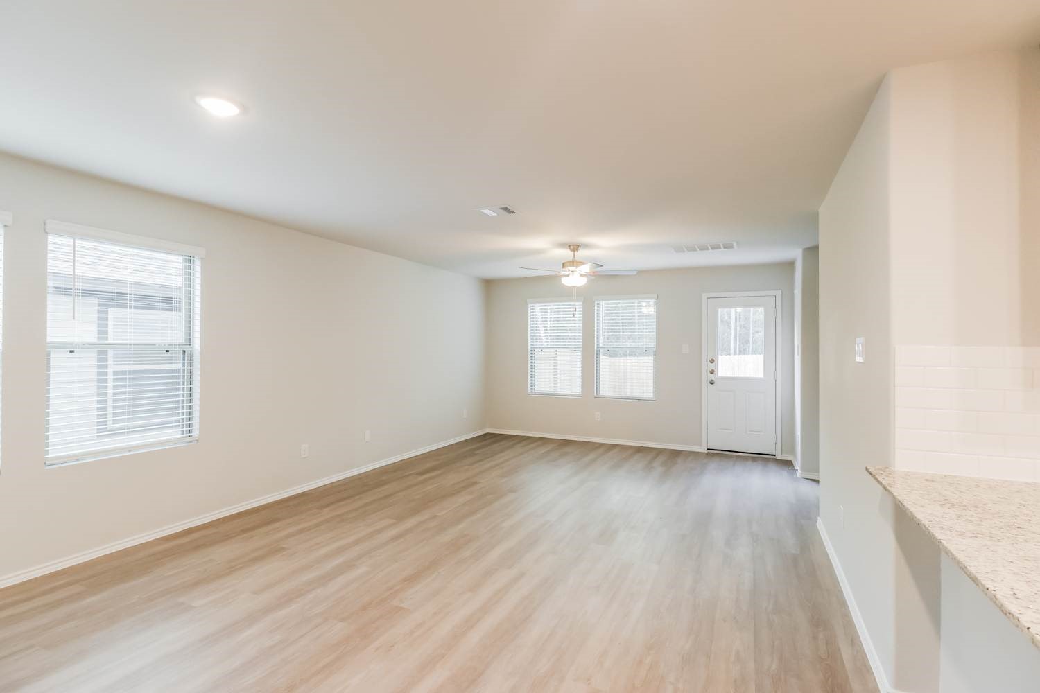 24812 Scilla Way Montgomery, TX 77316 - Photo 5 of 18 an empty room with wooden floor and windows