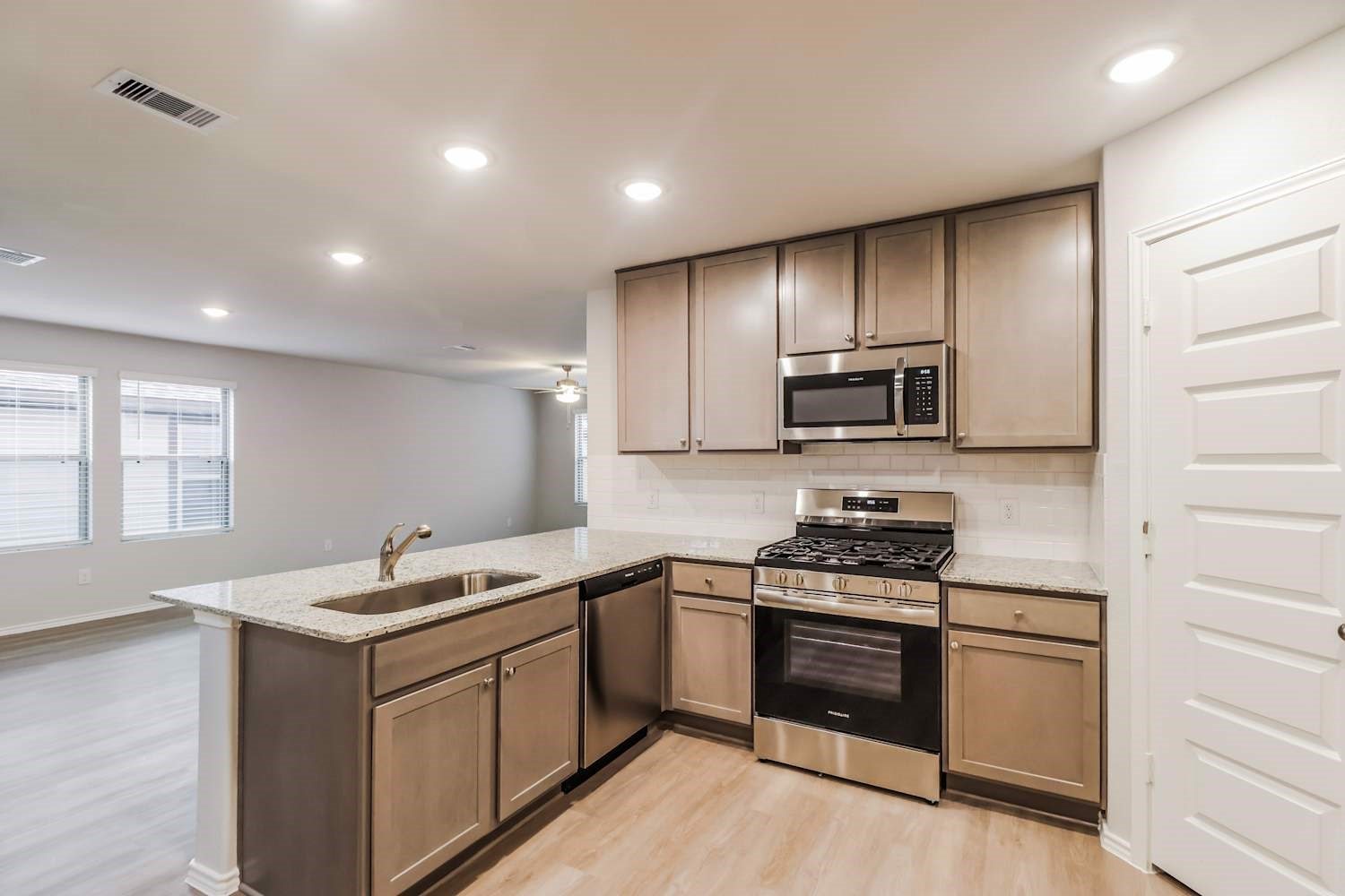 24812 Scilla Way Montgomery, TX 77316 - Photo 7 of 18 a kitchen with granite countertop stainless steel appliances and sink