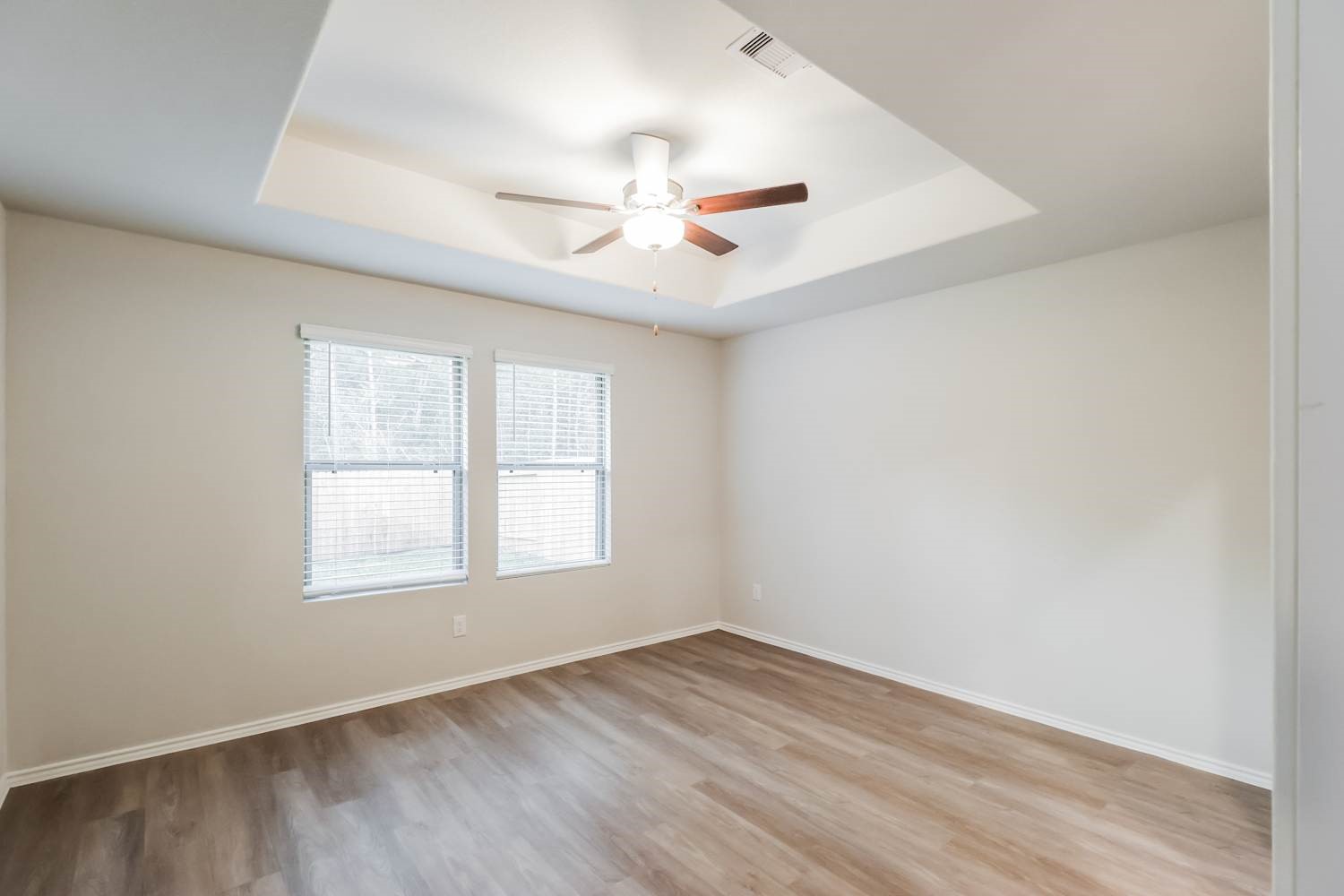 24812 Scilla Way Montgomery, TX 77316 - Photo 10 of 18 an empty room with wooden floor ceiling fan and windows