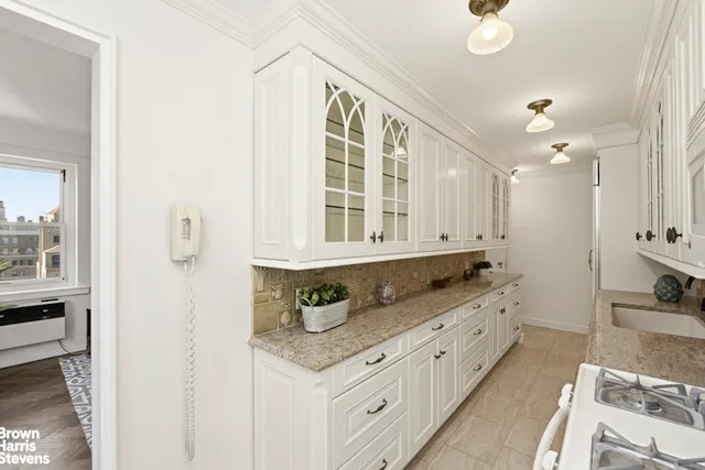 a bathroom with granite countertop a sink a vanity and a large mirror