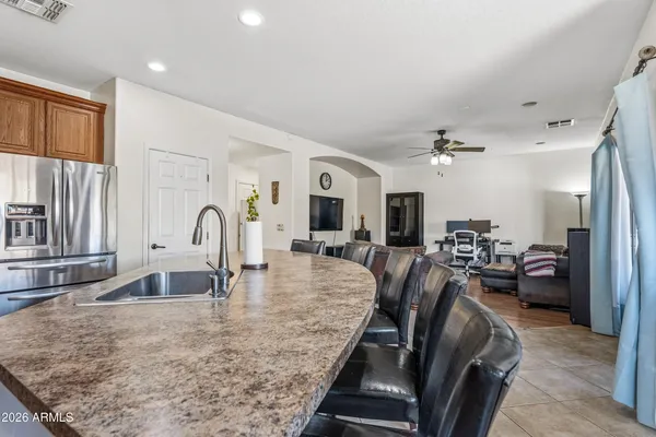 a large kitchen with stainless steel appliances granite countertop a lot of counter space