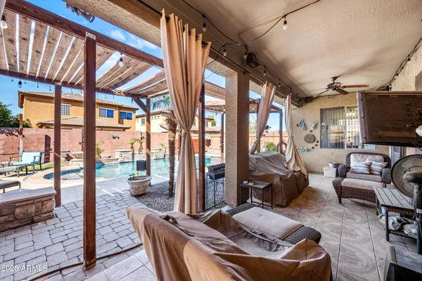 a living room with furniture a flat screen tv and a floor to ceiling window