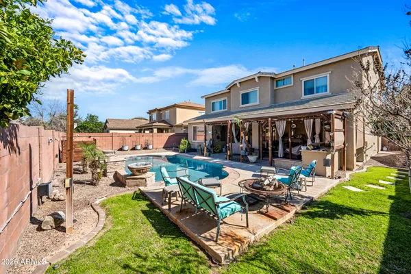 a view of a patio with couches chairs and a fire pit