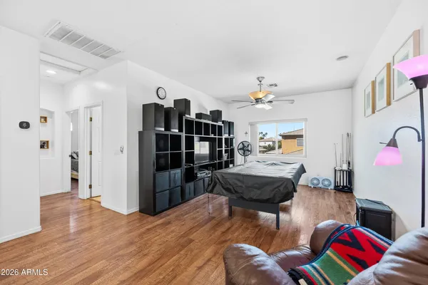 a bedroom with a bed a couch and a window